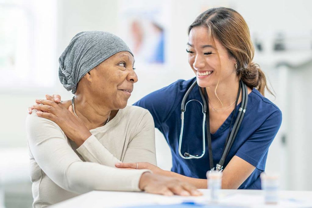 nurse comforting older patient