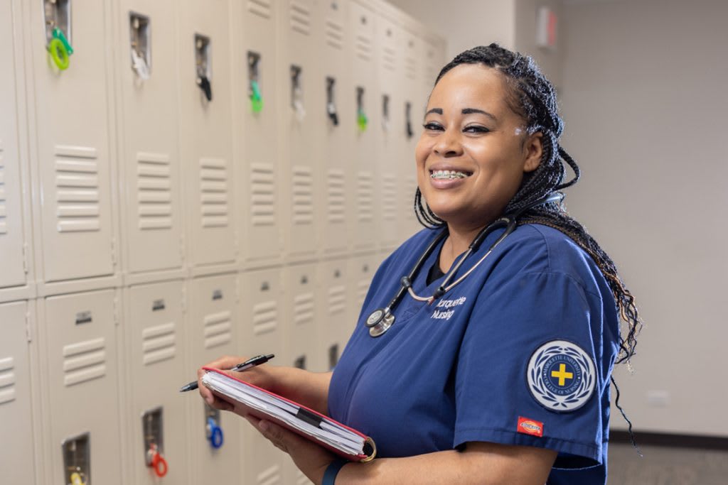 smiling portrait of nursing student holding clipboard