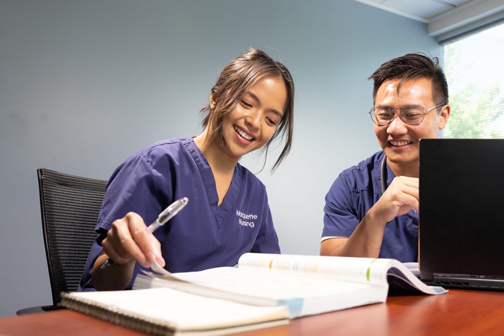 smiling nursing students studying