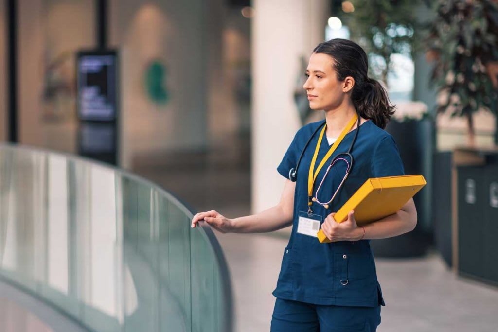 dark blue scrubs nurse with folder