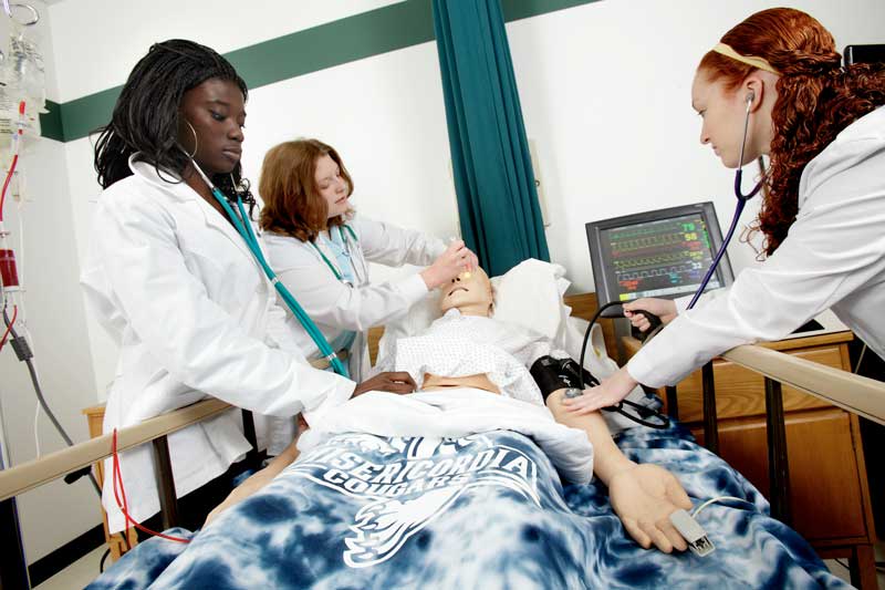 Nursing students working on manikin