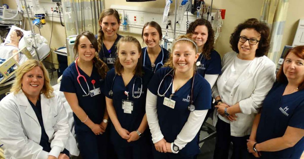 nursing students standing with instructors