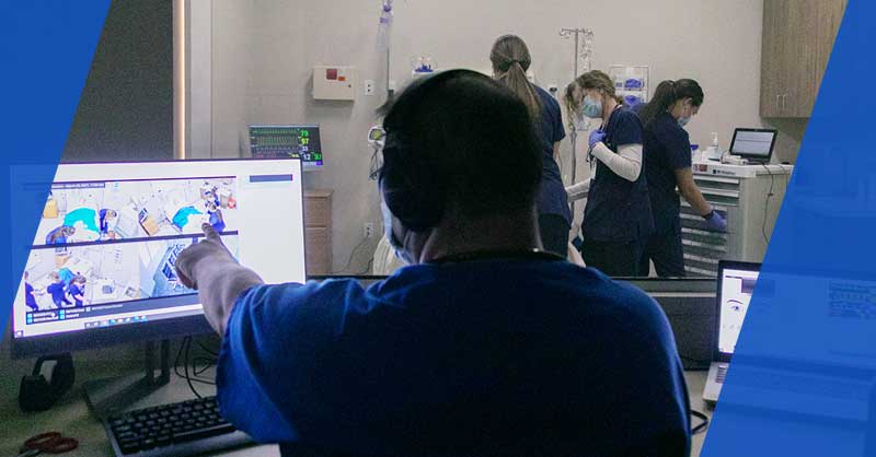 ABSN student viewing cohort in lab from a computer screen