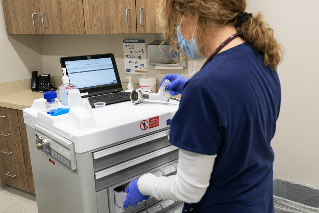 nursing student in lab using lab equipment