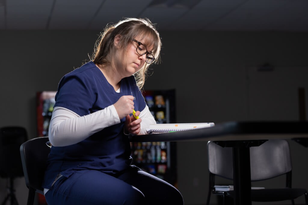 nursing student sitting at desk studying