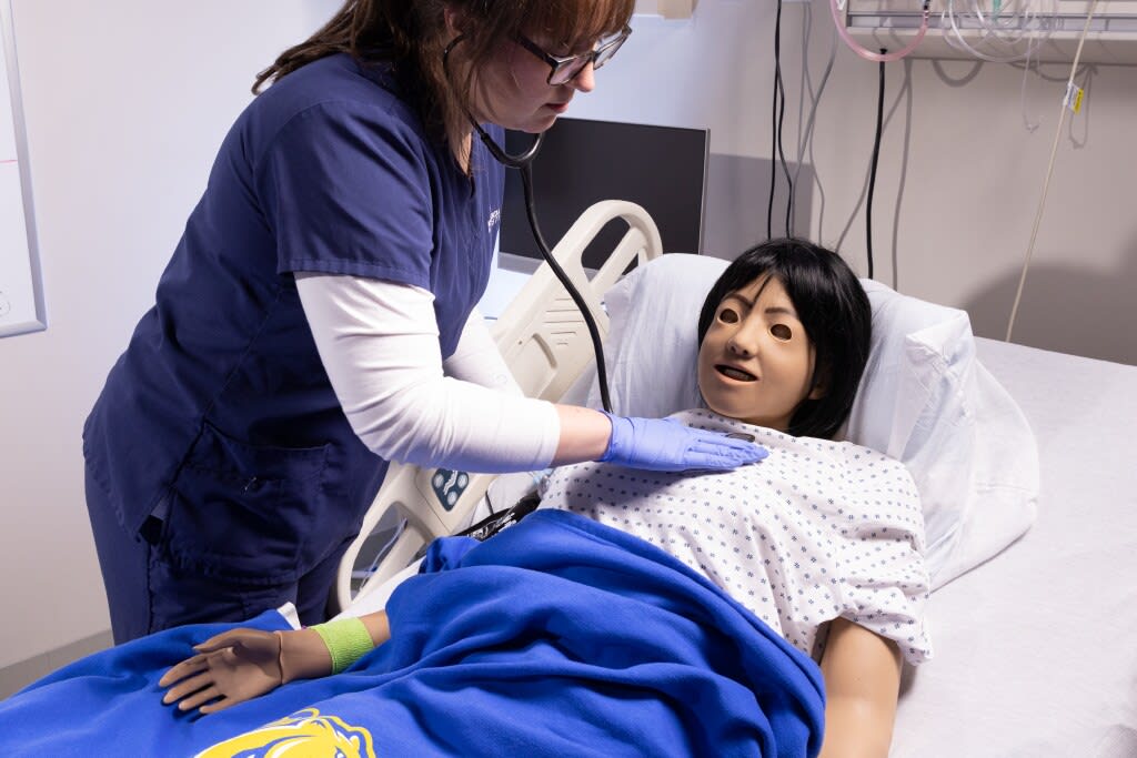 Misericordia nursing student using stethoscope on manikin