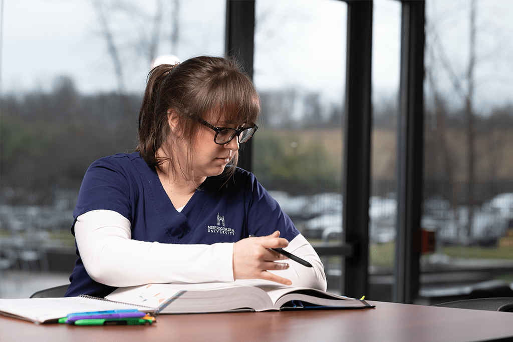 nursing student sitting at desk studying