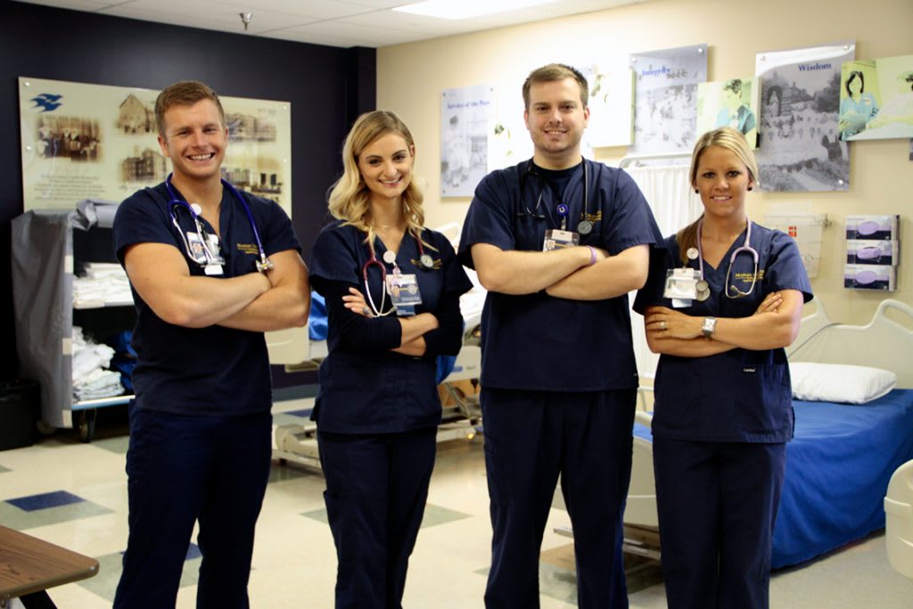 four Marian ABSN students crossing arms