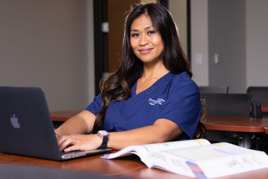Marian ABSN student using a laptop