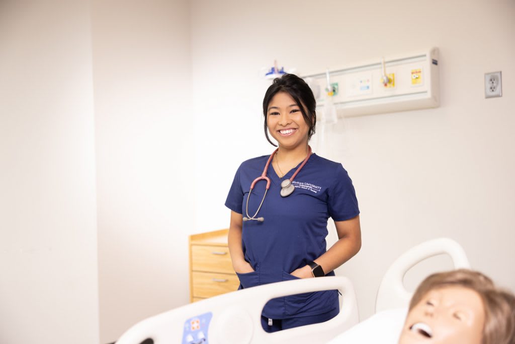 smiling Marian University ABSN student in sim lab