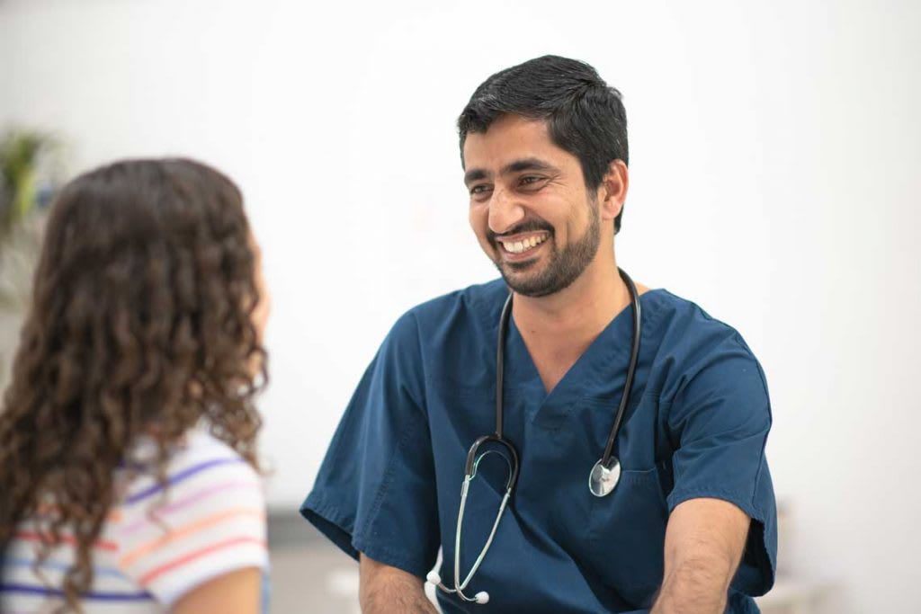 nurse sitting and talking with child patient