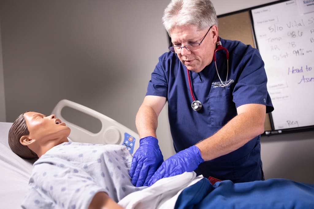 nursing student practicing on manikin