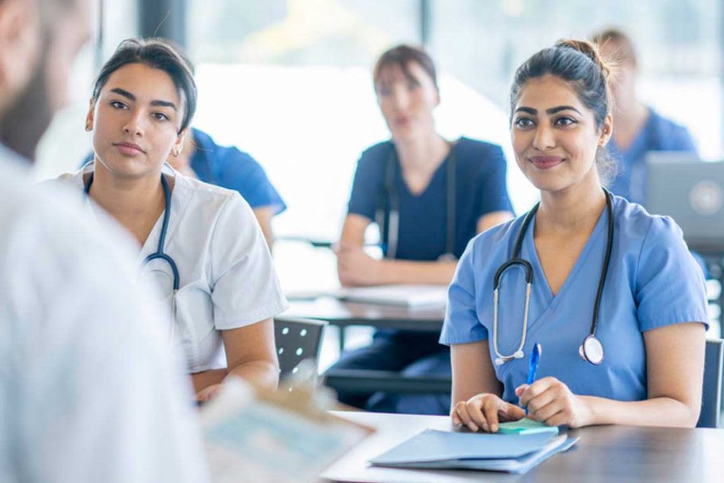 nursing students looking at a professor