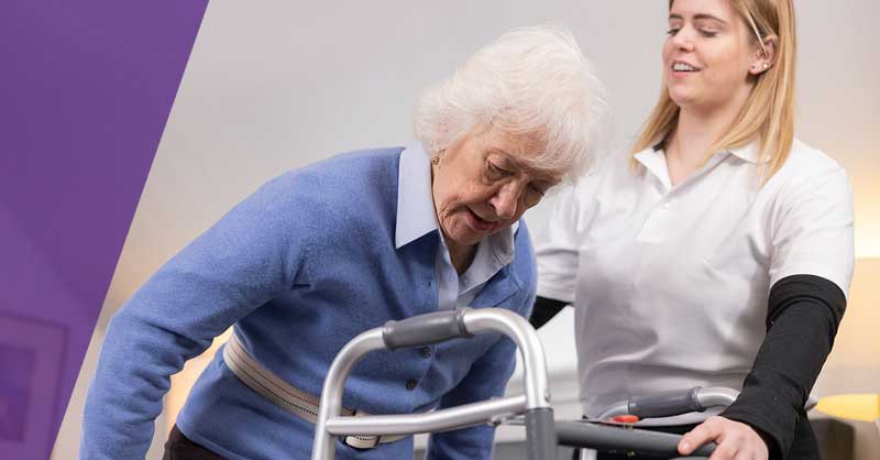 OTA helping elderly woman with walker