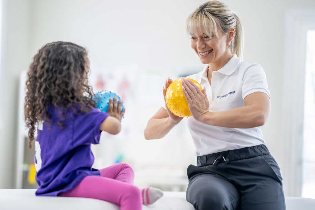 OT doing exercises with child patient