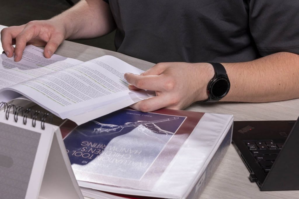 books and laptop on desk