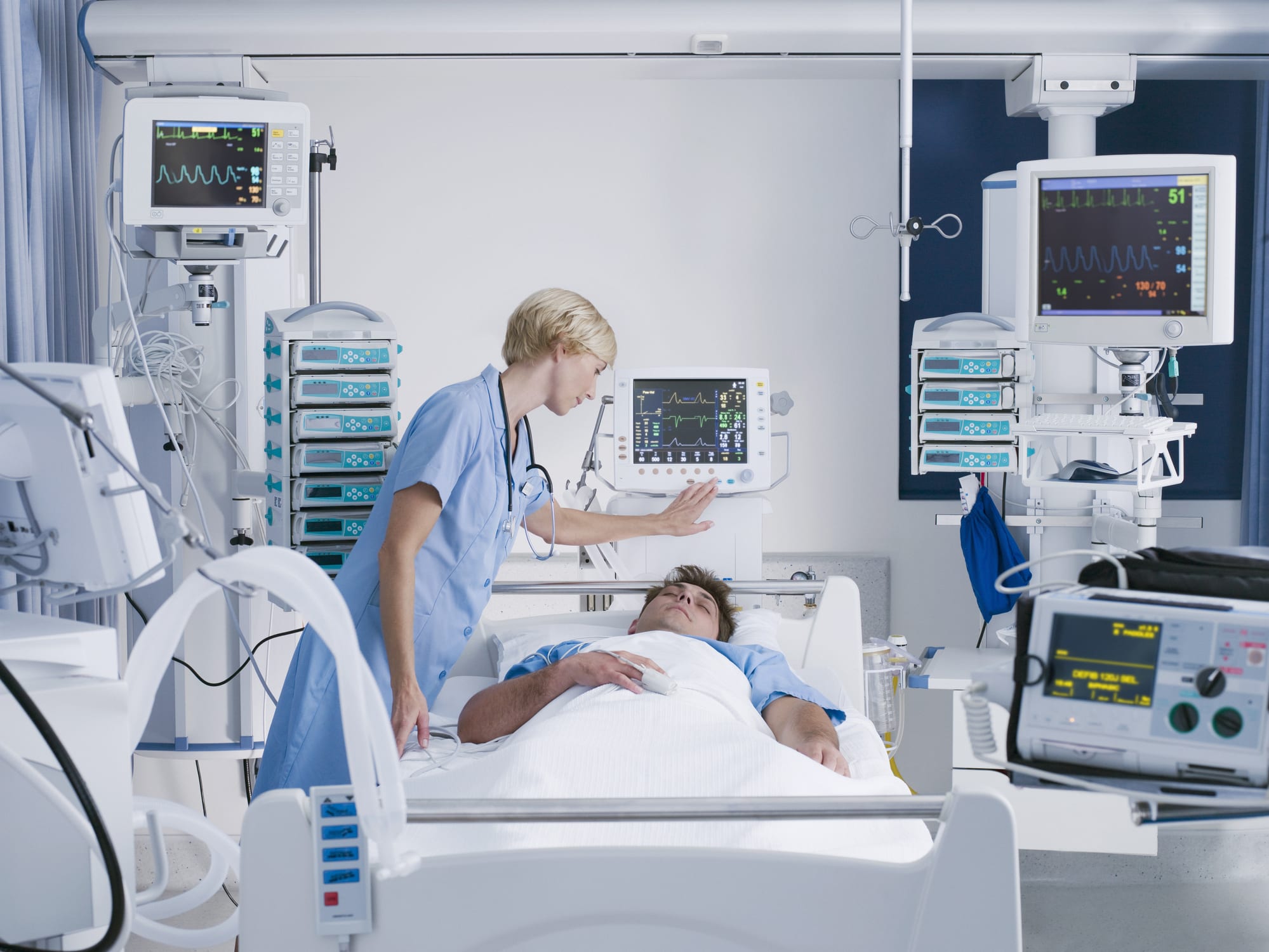 Nurse tending patient in intensive care