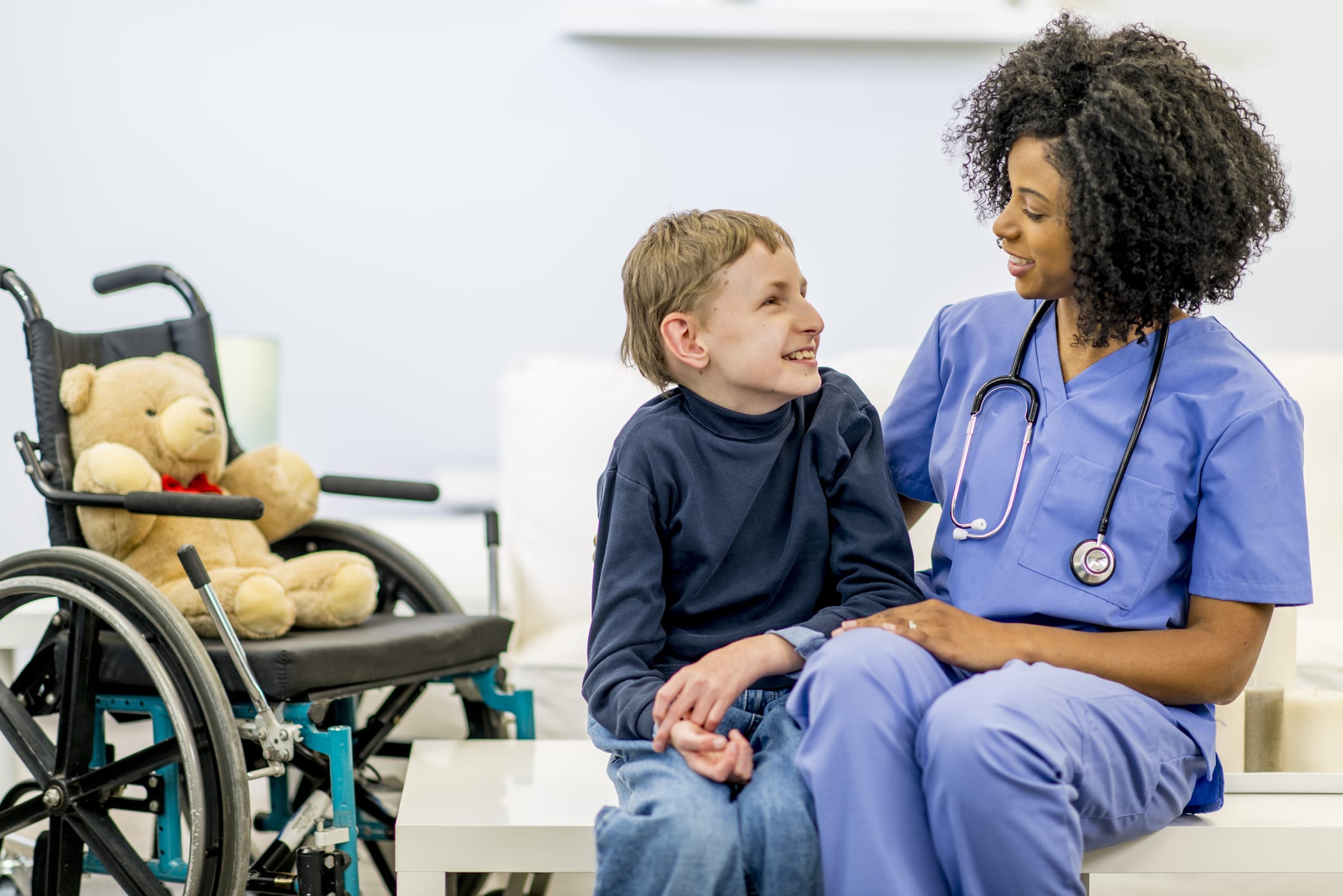 Nurse sitting with boy with Developmental Disability