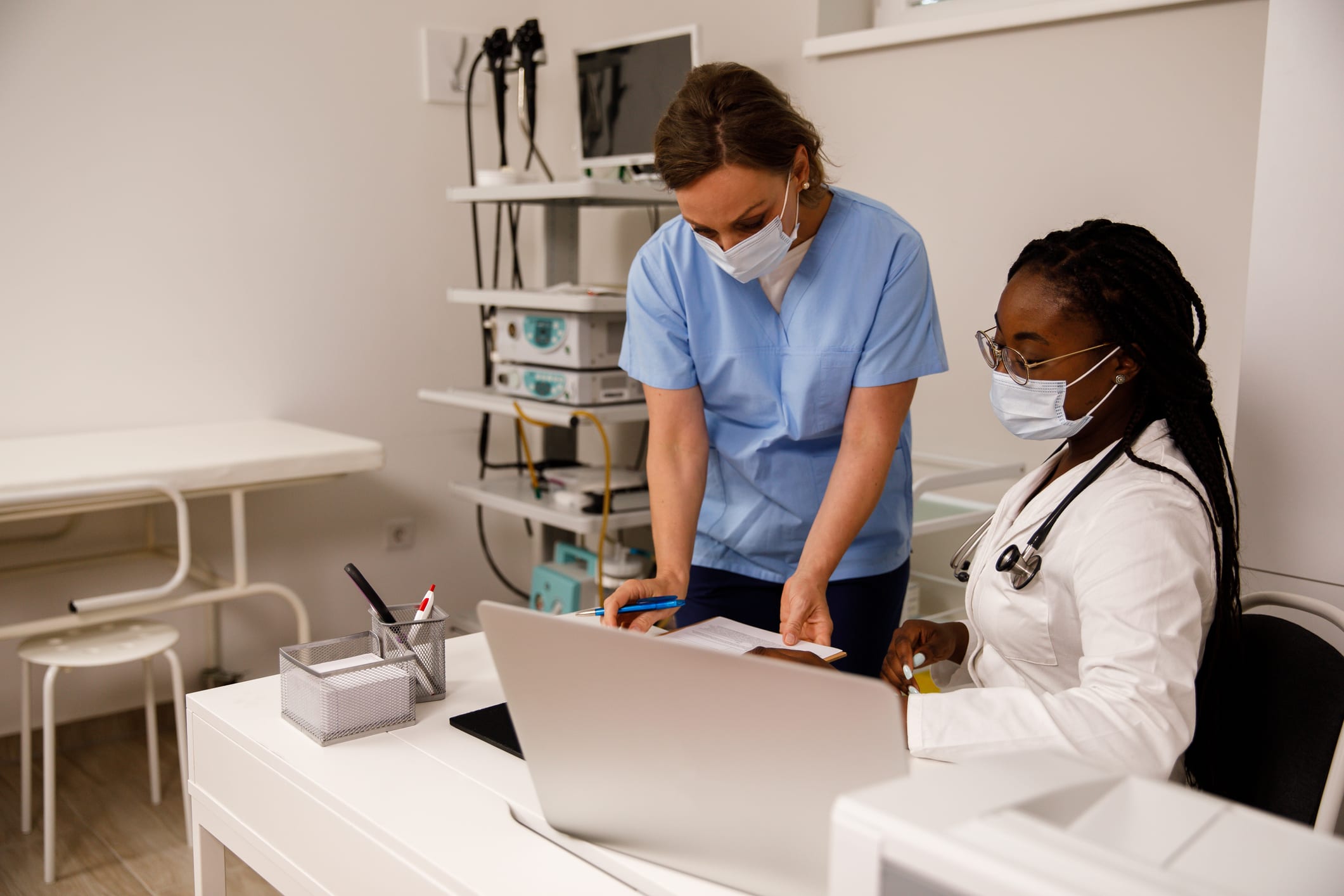 Nurse showing doctor patient's medical chart