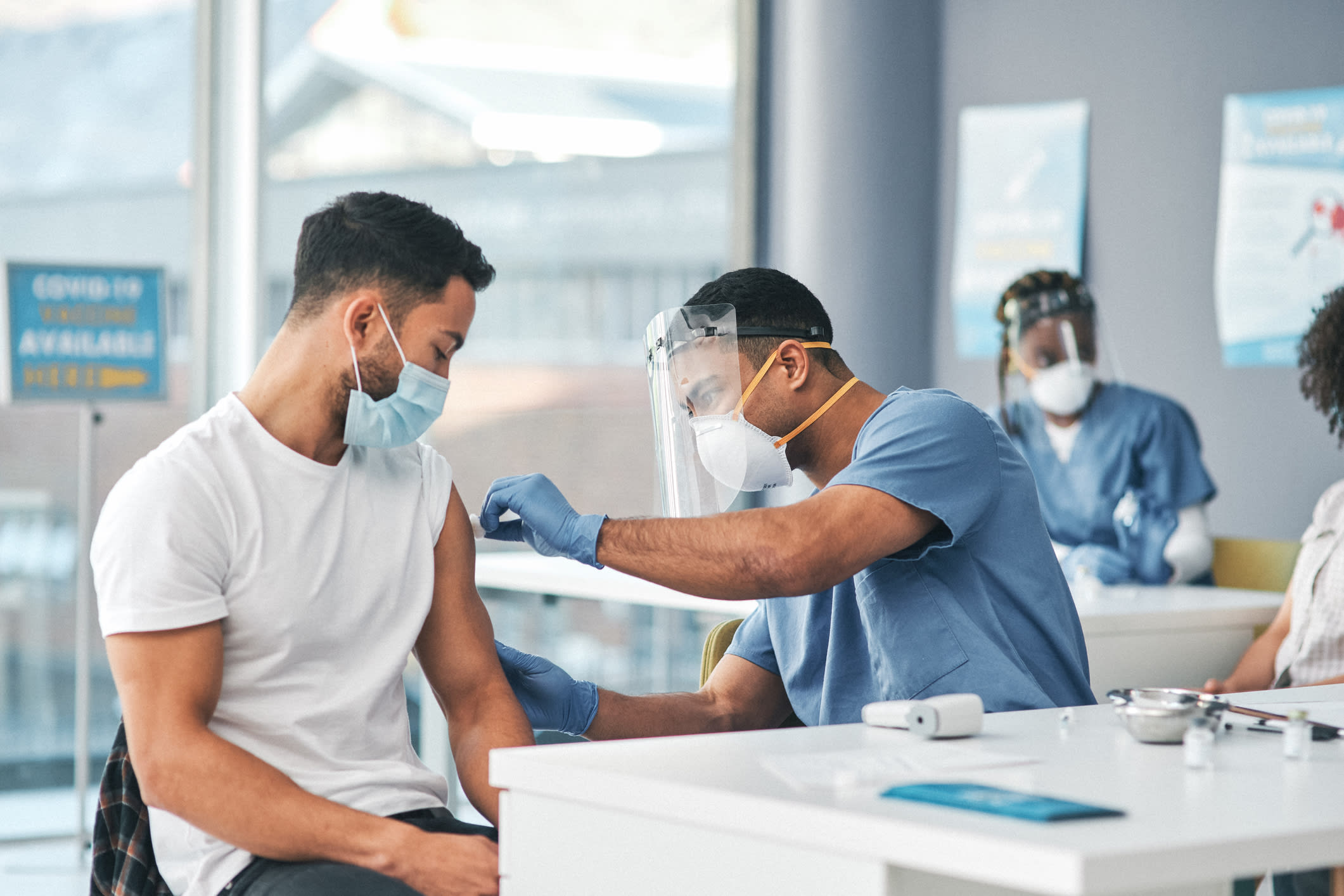 Shot of a person receiving an injection at a Covid-19 vaccination centre