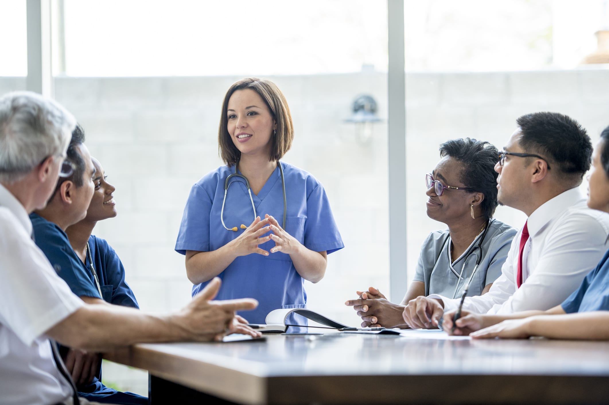 Nurse speaking to room of healthcare professionals