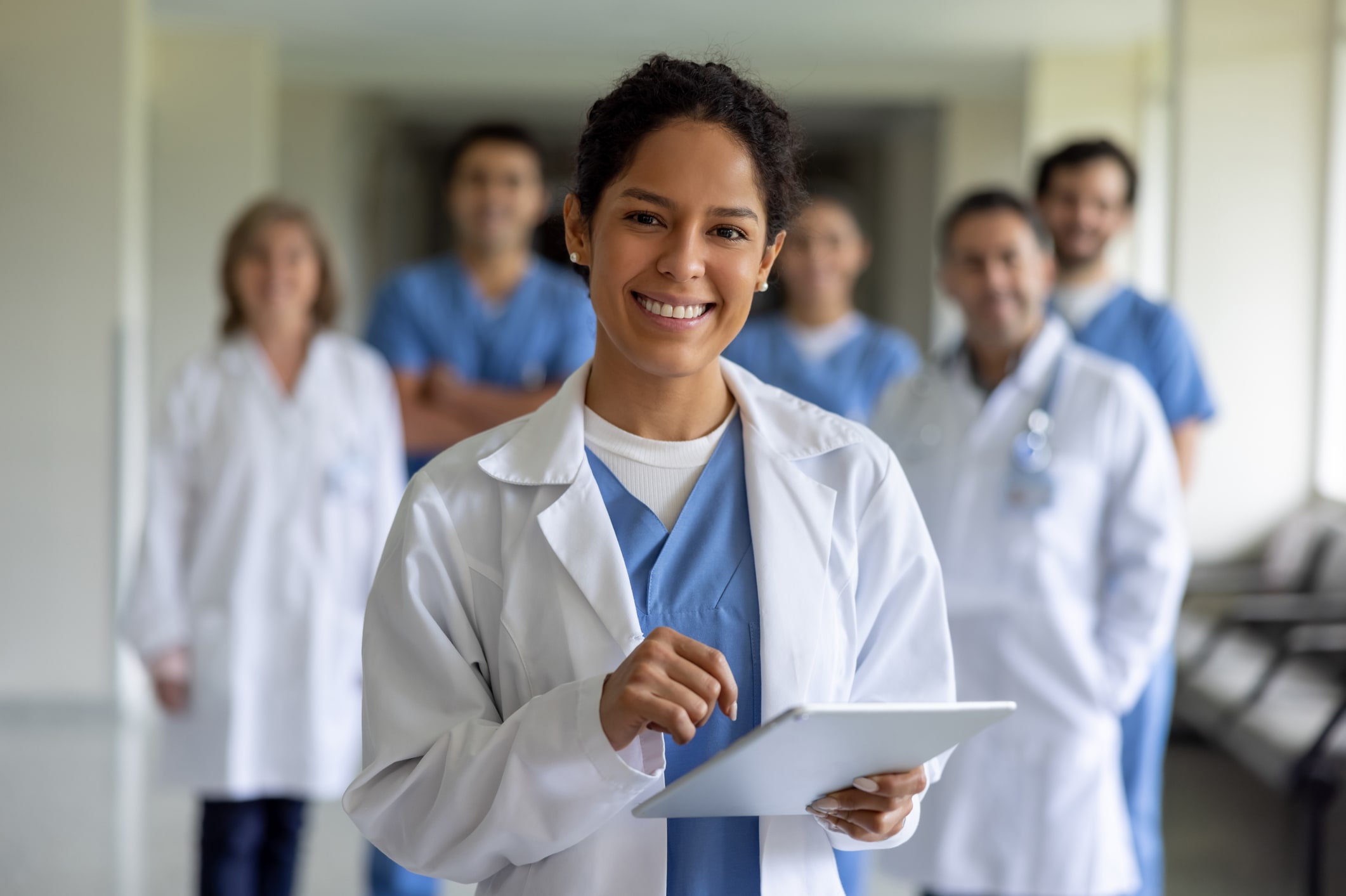 Happy doctor leading a team of healthcare workers at the hospital