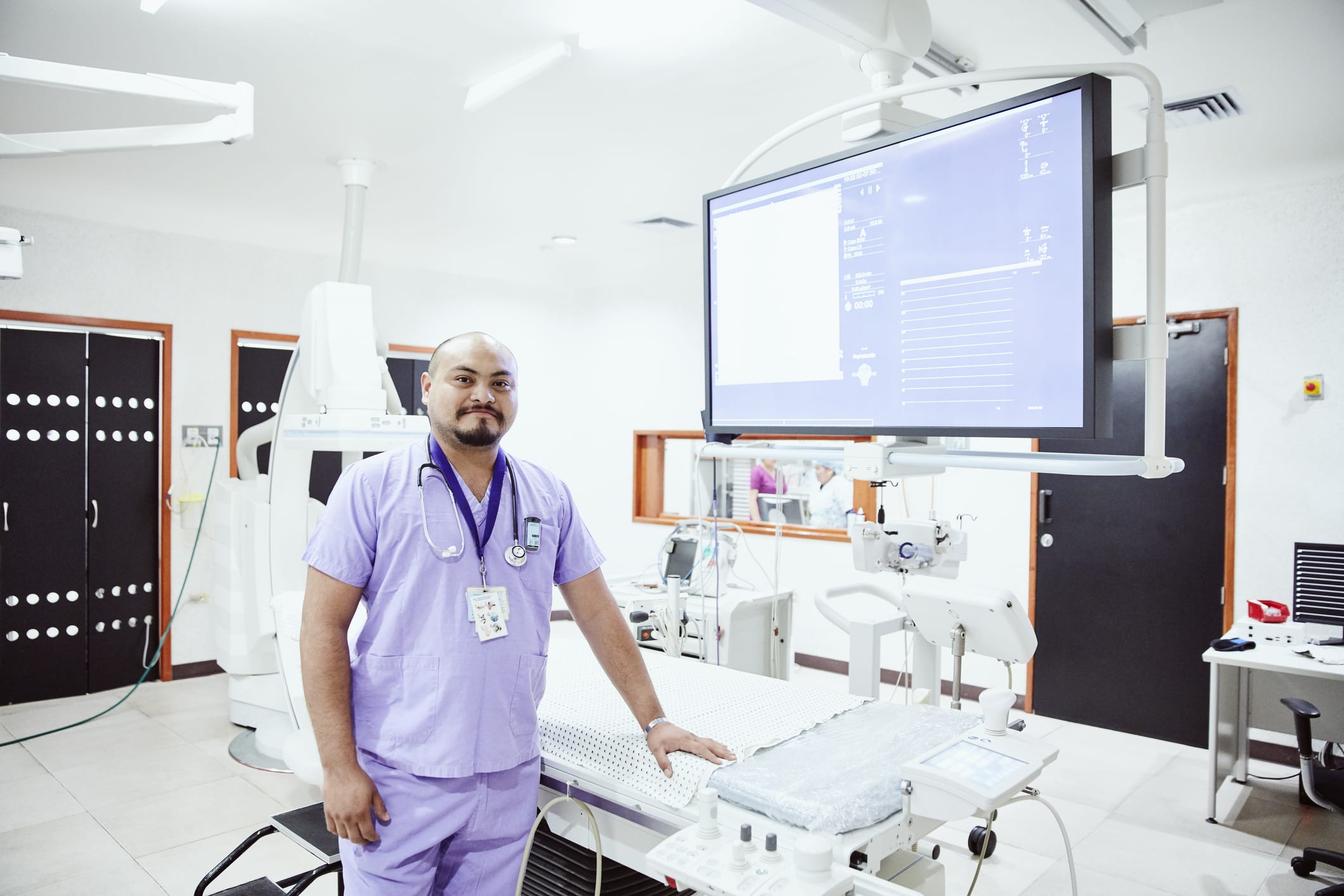 Nurse standing next to operating table