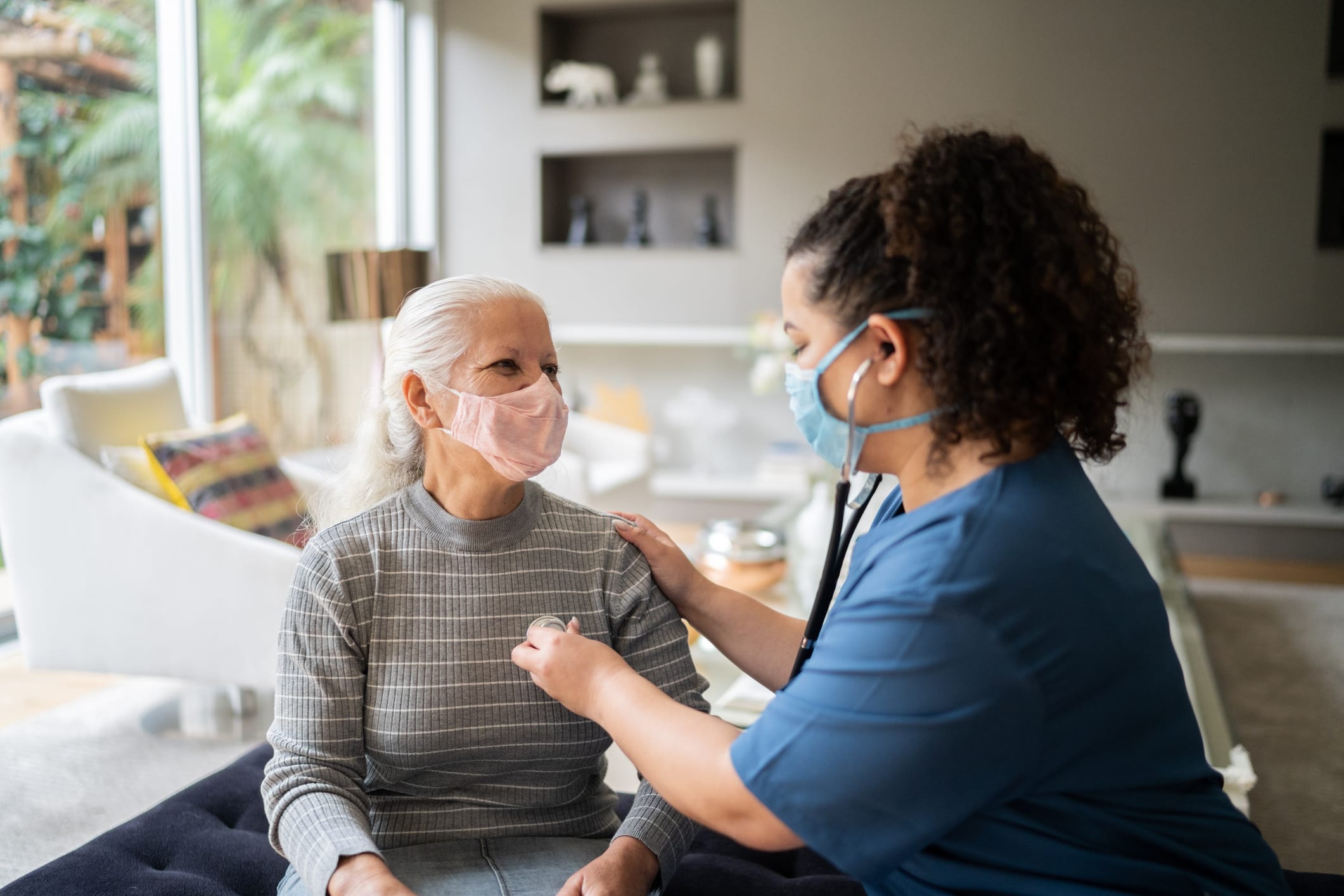 nurse listening to patient's heart beat