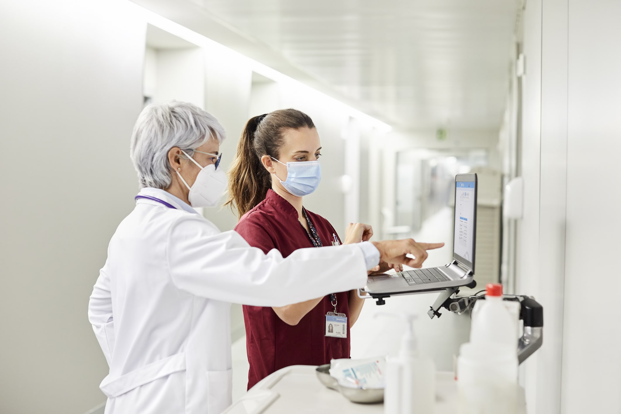 nurses pointing at computer screen