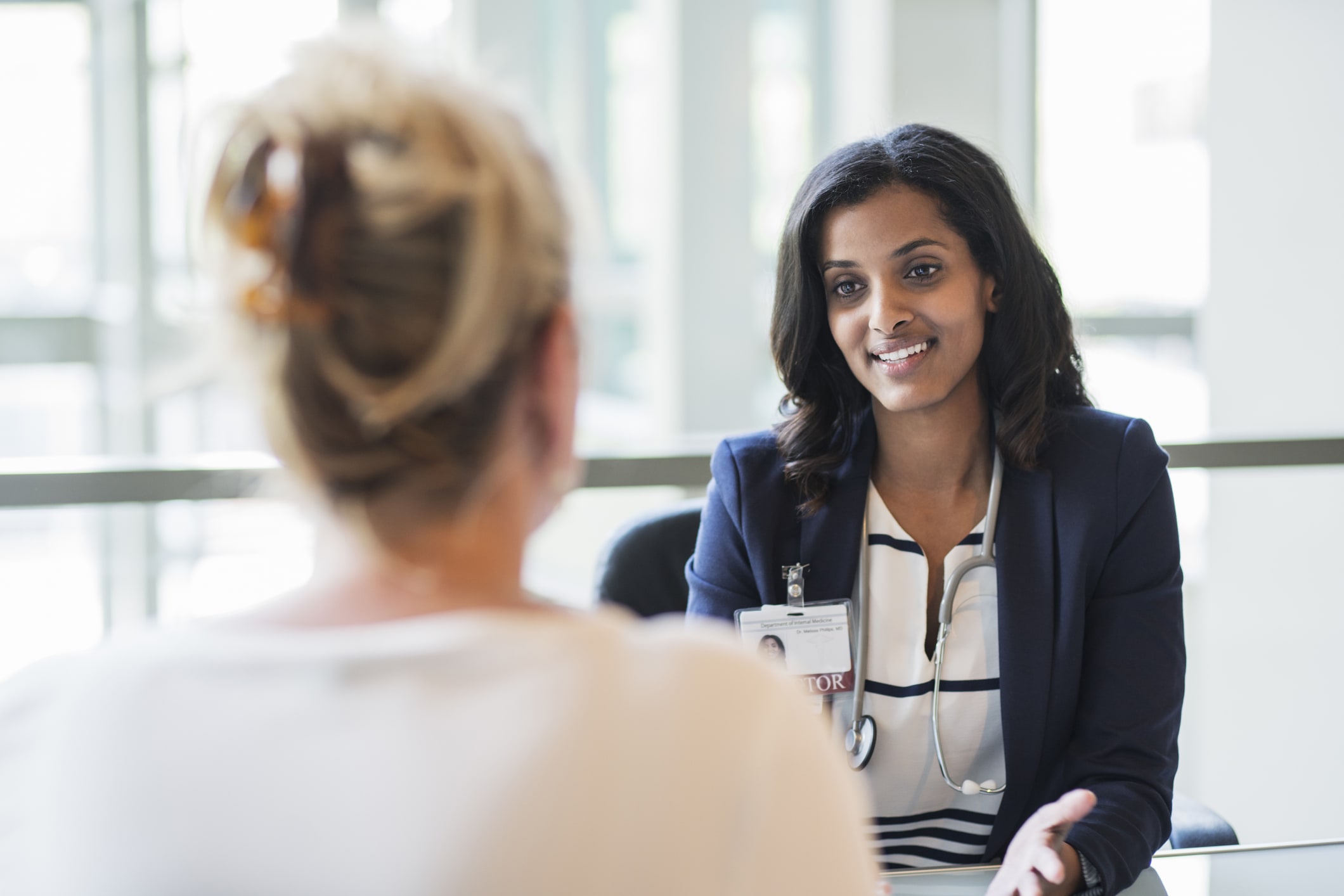 two women sitting at table talking