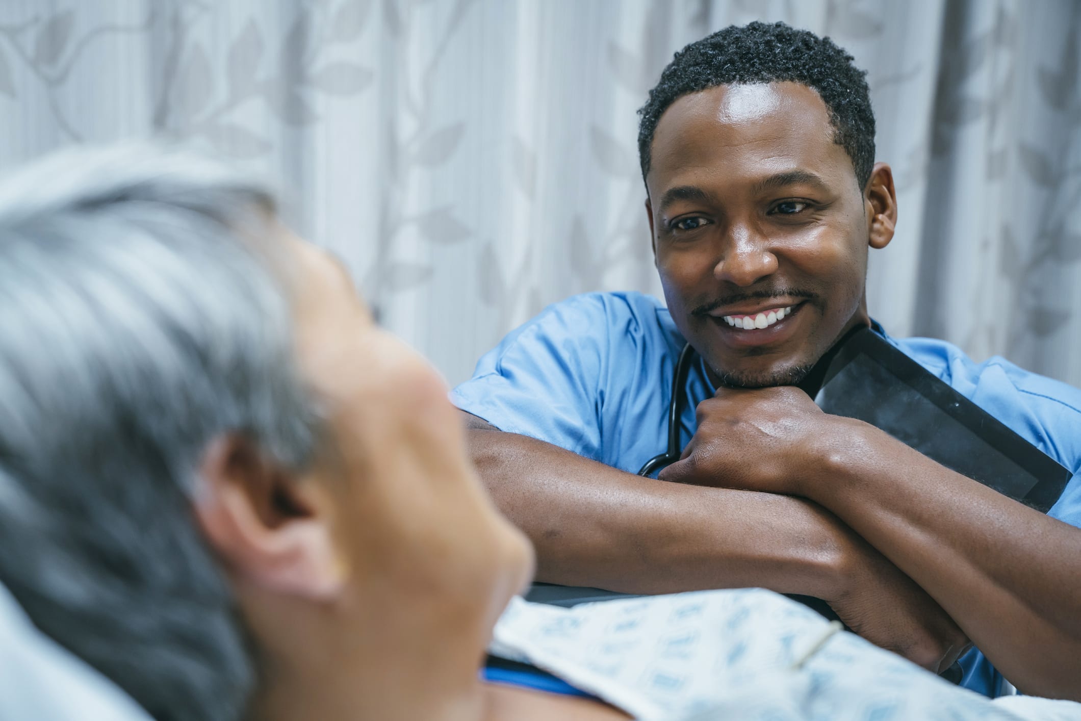 nurse at bed-side with patient