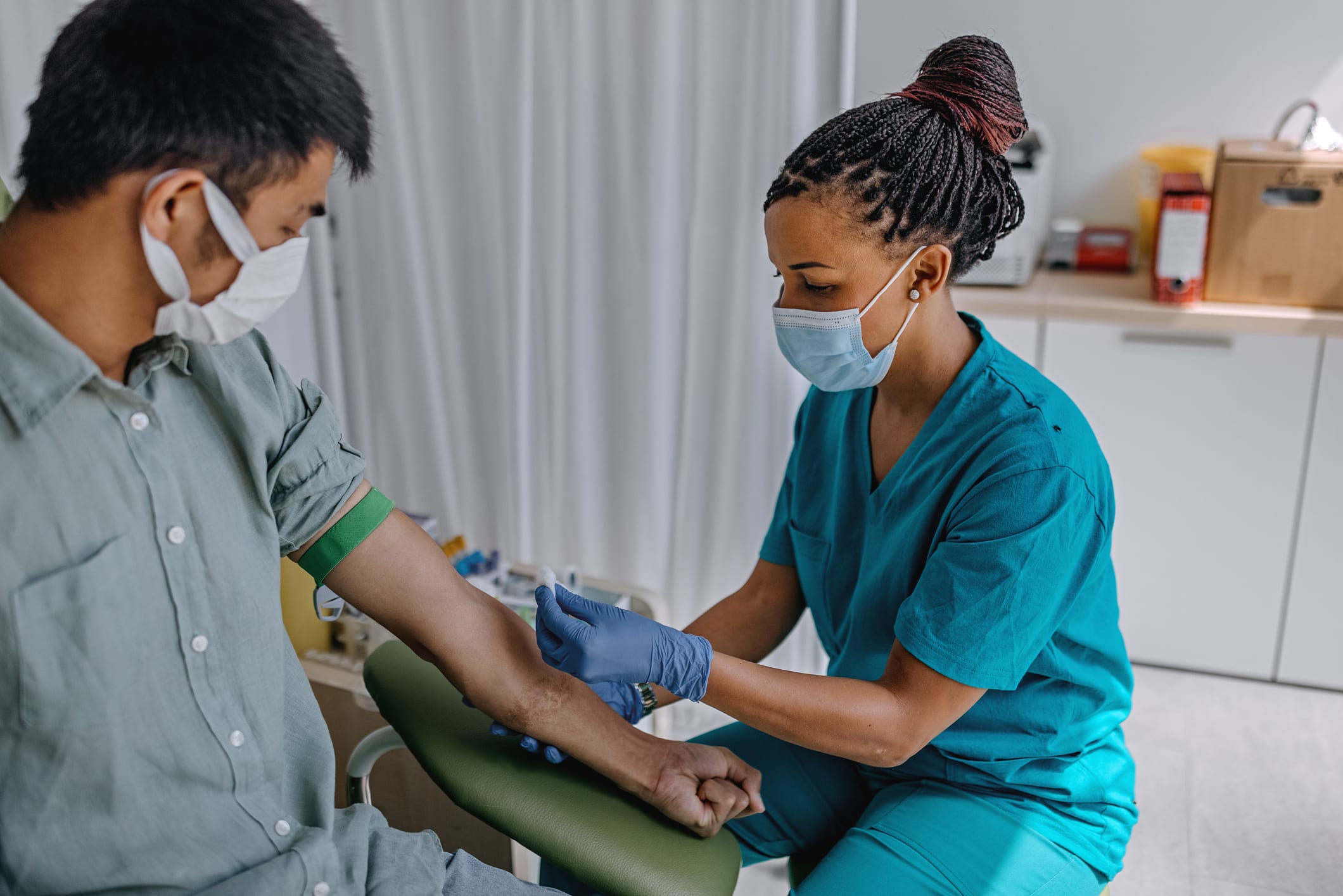 nurse helping with patient's arm