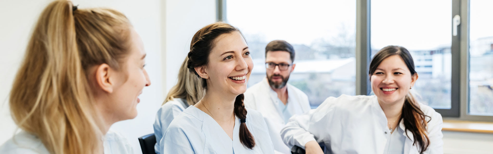 nurses sitting together in room talking