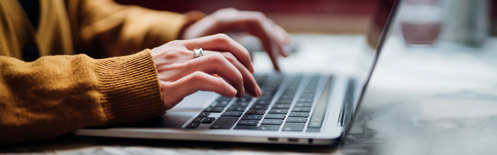 hands typing on laptop