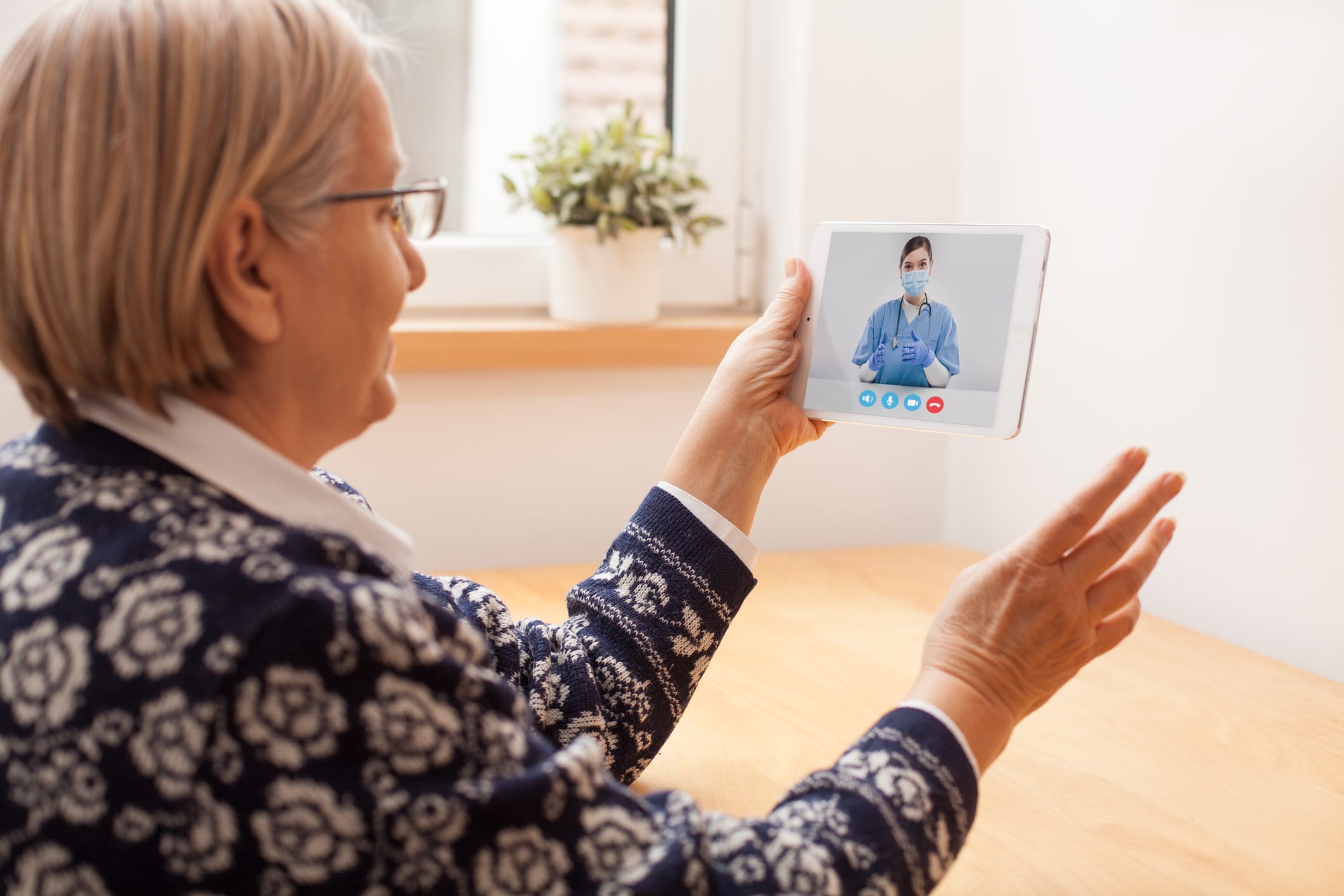 woman talking on tablet with nurse