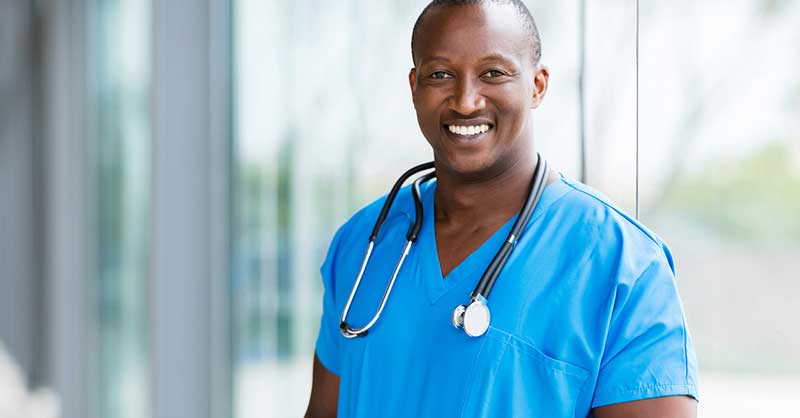 Male nurse wearing blue scrubs