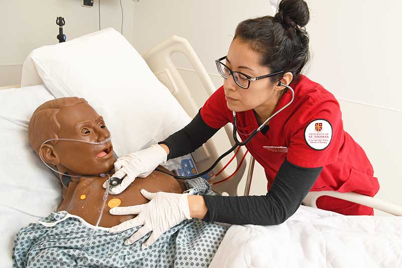 University of St. Thomas Houston nursing student working with simulation manikin