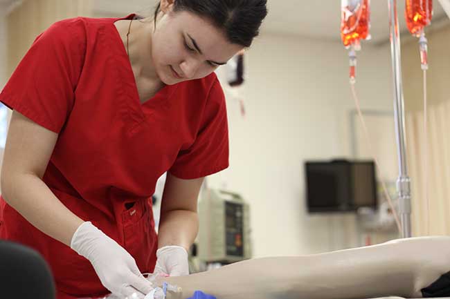 University of St. Thomas Houston nursing student working in skills lab