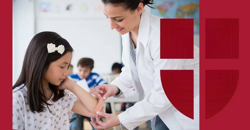 nurse helping student with a baind-aid