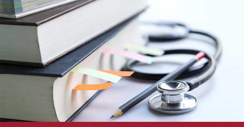 stethoscope sitting next to books