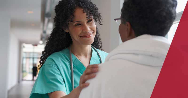 Nurse putting her hand on patient's shoulder