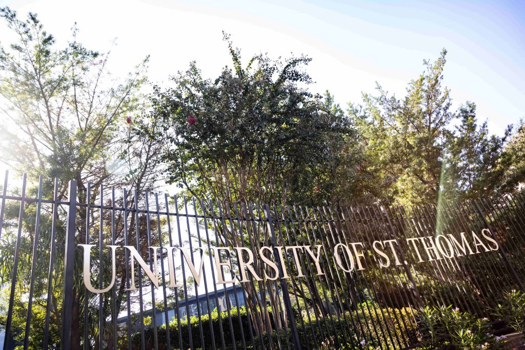 outside fence sign of University of St. Thomas