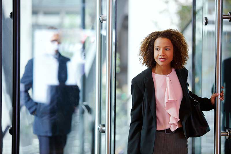 woman in work dress clothes entering building