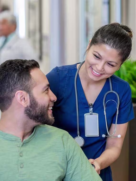 nurse in blue scrubs with patient