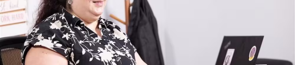 A woman at her desk on a laptop