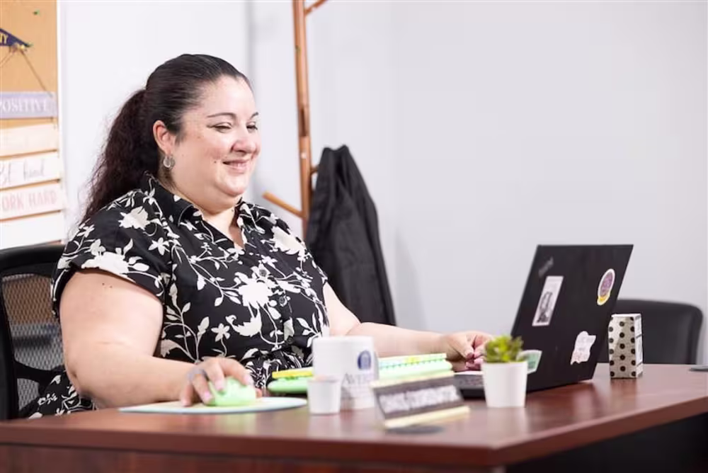 A woman at her desk on a laptop