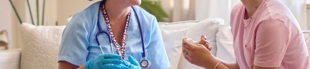 Nurse sitting with a patient in the patients home