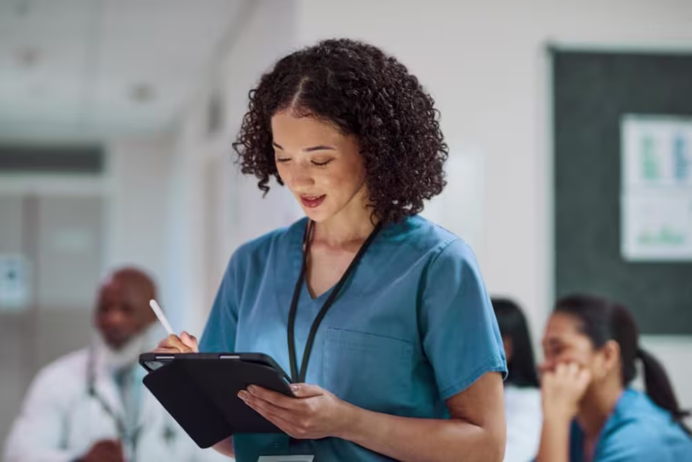 Nurse looking down at her tablet 