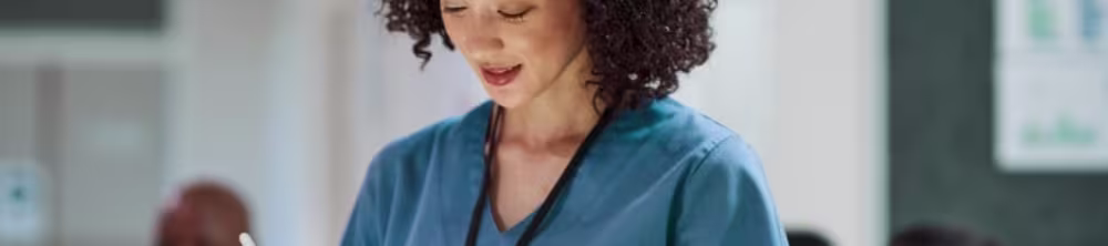Nurse looking down at her tablet