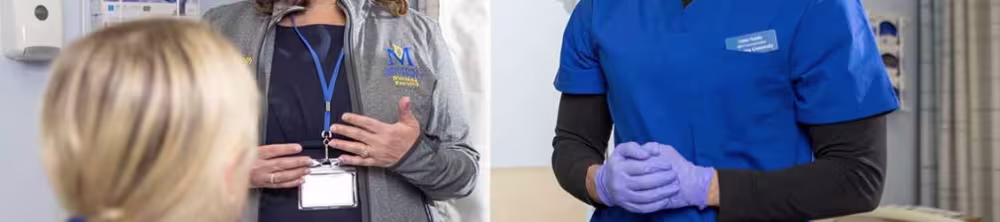 nursing instructor talking with ABSN students in lab